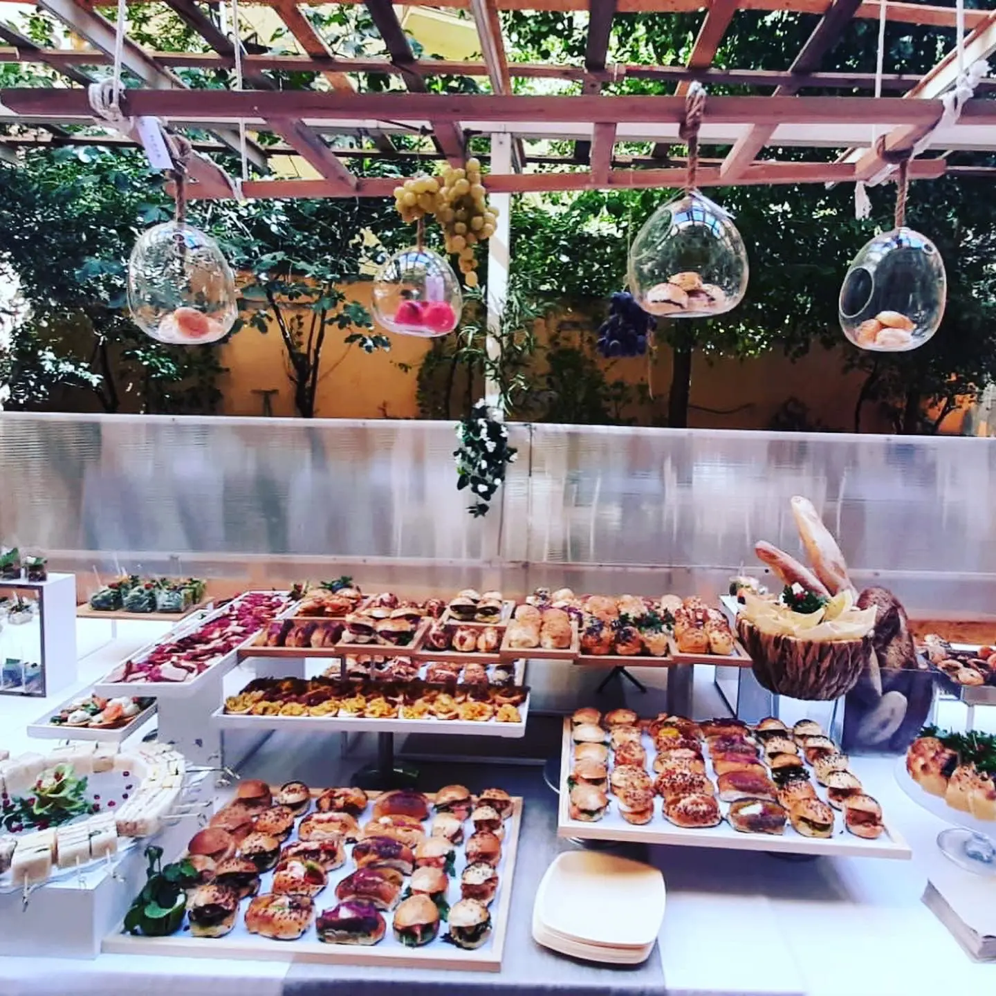 Buffet di finger food e specialità kosher allestito sotto una pergola da Flour Ricevimenti a Roma